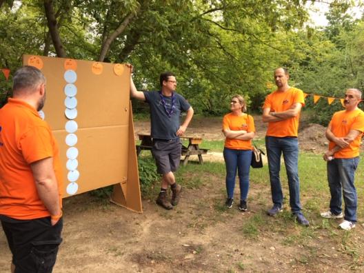 Menschen vor einer Pinnwand im Grünen