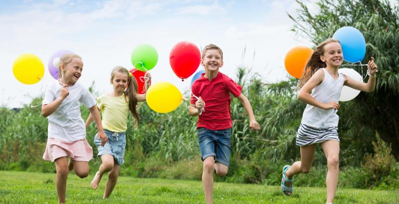 Endlich haben die Kinder Sommerferien Kinder fröhlich im Park mit Luftballons